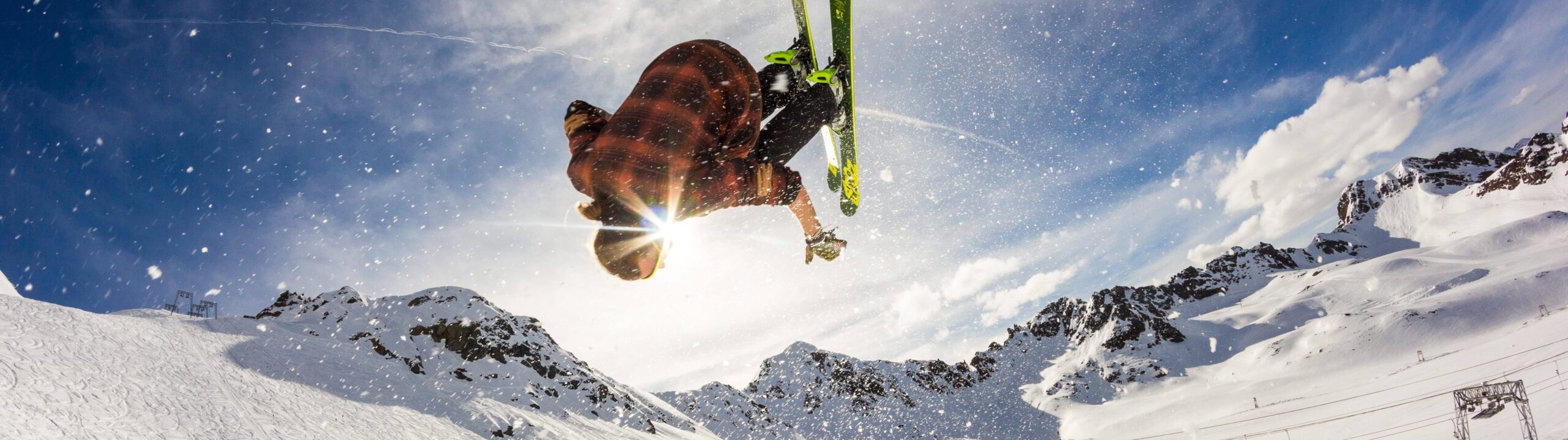An individual doing a backflip on a snowboard, enjoying Winter fun in the Poconos