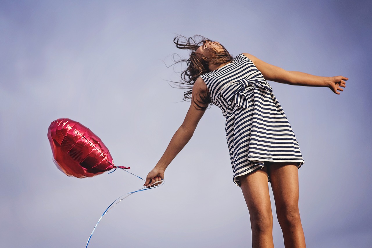 A woman holding a balloon during summer in the poconos